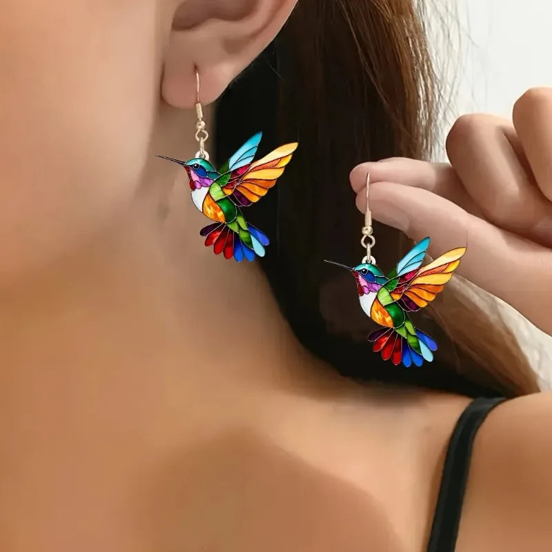 Acrylic hummingbird earrings featuring vibrant rainbow colors, lightweight 2.5-inch statement dangles perfect for adding a pop of color to any outfit. 0