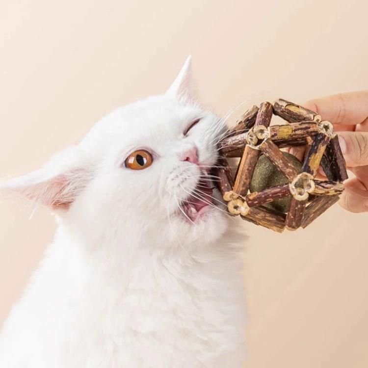Cat chew toy featuring silvervine sticks and a jingle bell, designed as a natural aromas cage ball to promote dental health and engage playful felines. 1