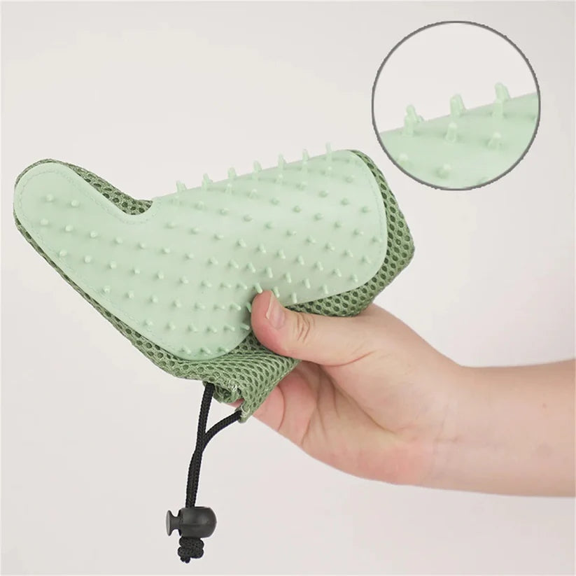 Cat grooming glove featuring an ergonomic design and soft silicone tips, perfect for easy fur removal on all fur types. 6