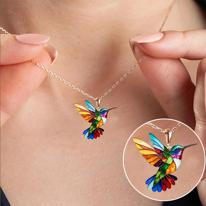 Colorful hummingbird necklace pendant featuring multicolor stained detail, crafted from gold-plated stainless steel, perfect for adding a vibrant touch to any outfit. 0