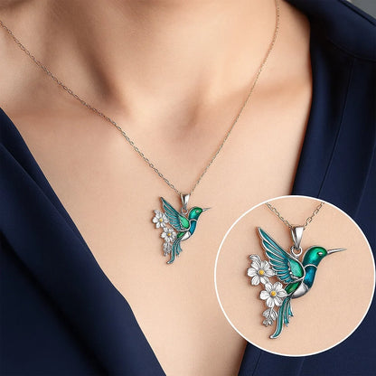 Sterling silver jewelry set featuring a stunning teal enamel hummingbird design, including a matching necklace and earrings, perfect for nature lovers and elegant occasions. 3